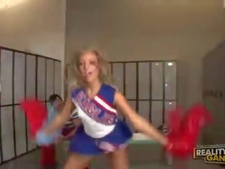 Adorable blonde teen cheerleader talking with her teacher